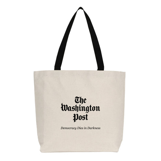 Natural cotton Washington Post tote bag with black shoulder straps featuring The Washington Post logo and Democracy Dies in Darkness slogan.