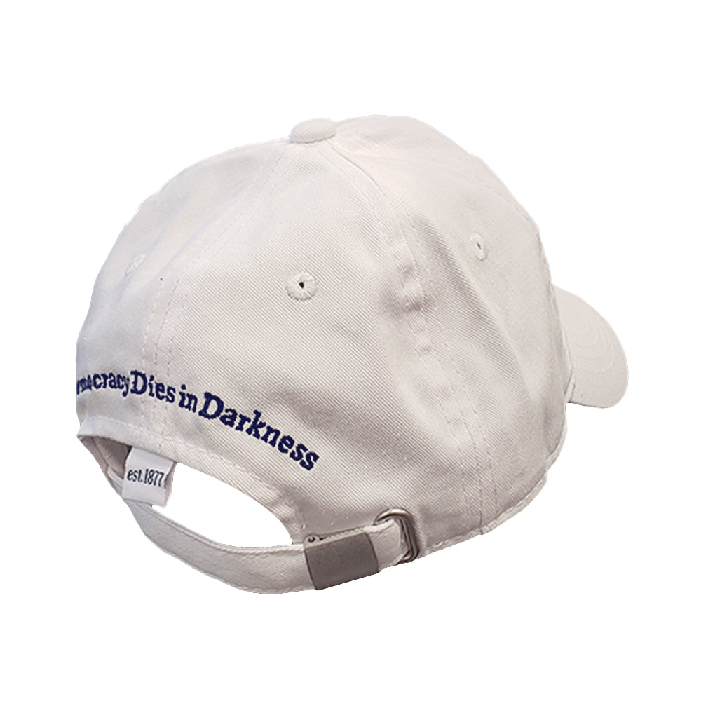 Back of white baseball cap with "Democracy Dies in Darkness" in navy lettering