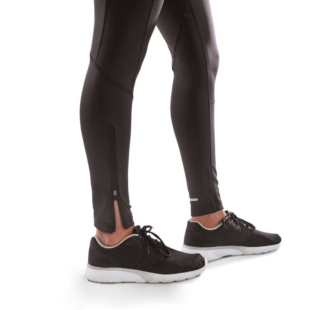 Close up of bottom of black leggings with zippers on the calves.