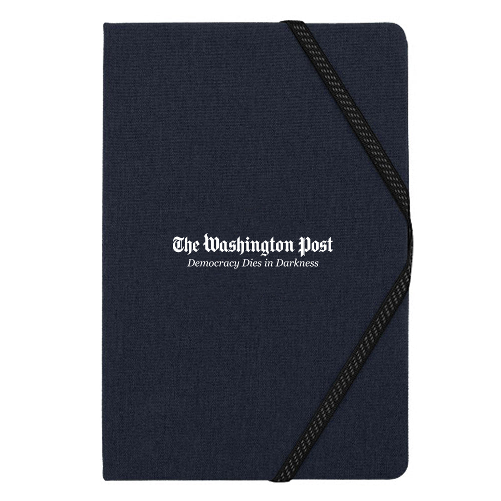 Dark Blue journal with The Washington Post and Democracy Dies in Darkness in the center in white text and a black elastic band to hold the page.