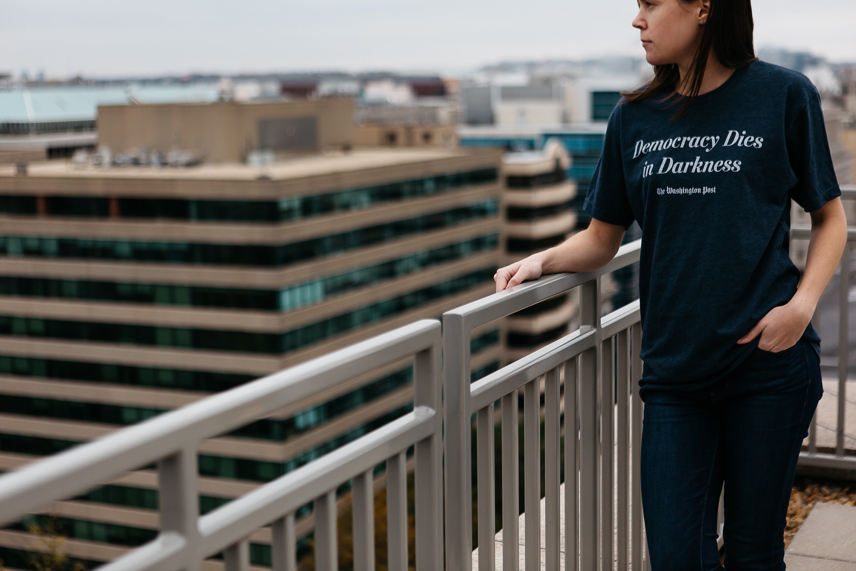 Model wearing Democracy Dies in Darkness T-shirt in navy with white lettering